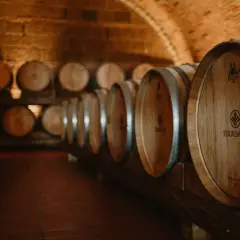Cantina con botti di legno invecchiate, pronte per il vino. Il tempo passa, ma il vino scade solo se non curato.