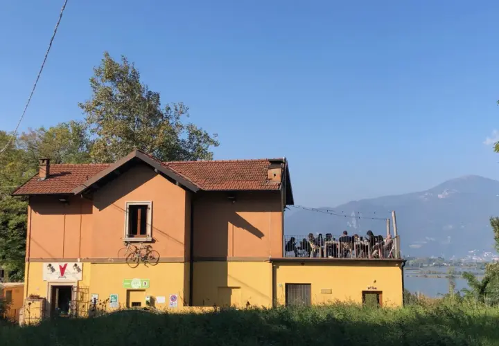 Un locale con tavoli all'aperto e vista sul lago d'Iseo, dove si respira l'atmosfera delle cantine locali.